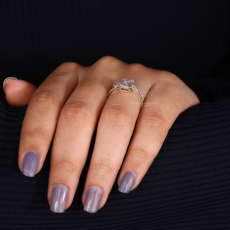 Yellow gold muse engagement ring with diamond side stones.
