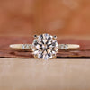 round engagement ring with yellow gold ring band.
