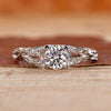 Nature inspired engagement ring with round diamond center.
