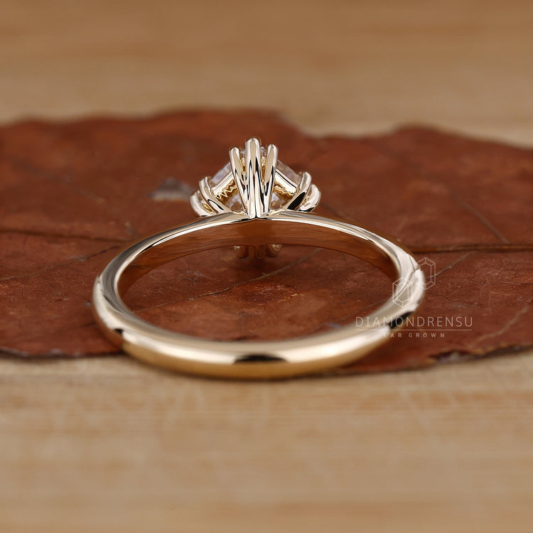 Asscher cut diamond ring in triple prong setting.
