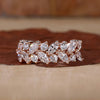 Rose gold wedding band with prong setting.
