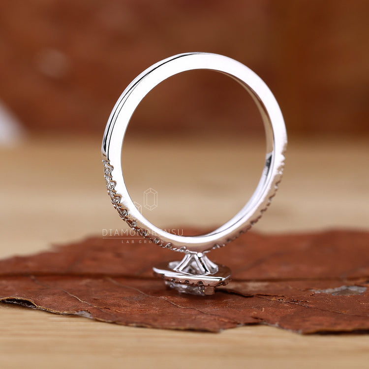 Halo engagement ring in rose gold with pave setting.
