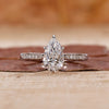 pear cut engagement ring with tapered pave band.
