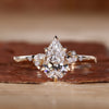 Pear Cut Diamond Ring with Round and Marquise Side Stones