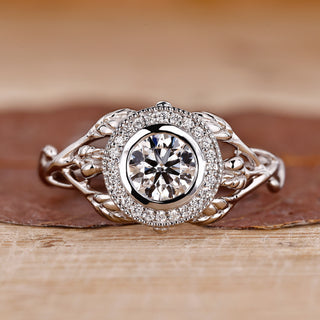 Bezel setting ring with round diamond and milgrain details.

