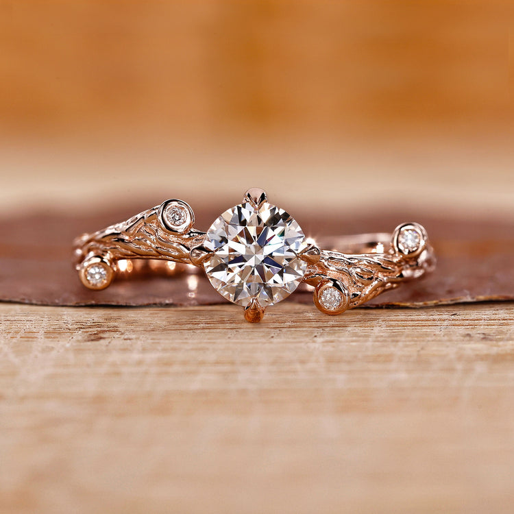 Rose gold engagement ring with round cut diamond and four claw prong setting.
