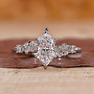 White gold engagement ring with Dutch marquise diamond and round side stones.
