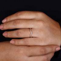 Round cut diamond band in curvy wedding band.
