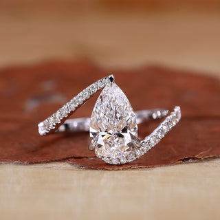Pear shaped engagement ring with white gold engagement ring.
