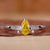 Yellow diamond pear engagement ring with pave diamond band.
