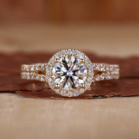 Halo diamond engagement ring in yellow gold with pavé detailing.
