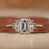 Emerald cut engagement ring with yellow gold engagement ring.
