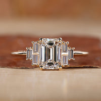 Emerald cut engagement ring with yellow gold engagement ring.

