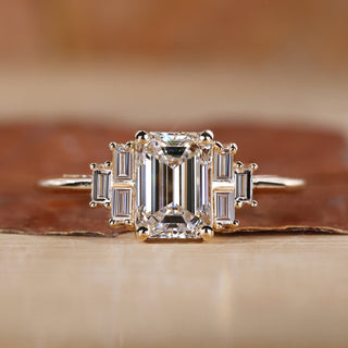 Emerald cut engagement ring with yellow gold engagement ring.
