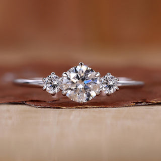 3 stone engagement ring with round centre diamond.
