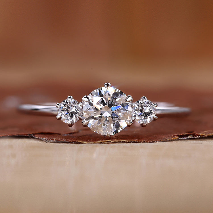 3 stone engagement ring with round centre diamond.
