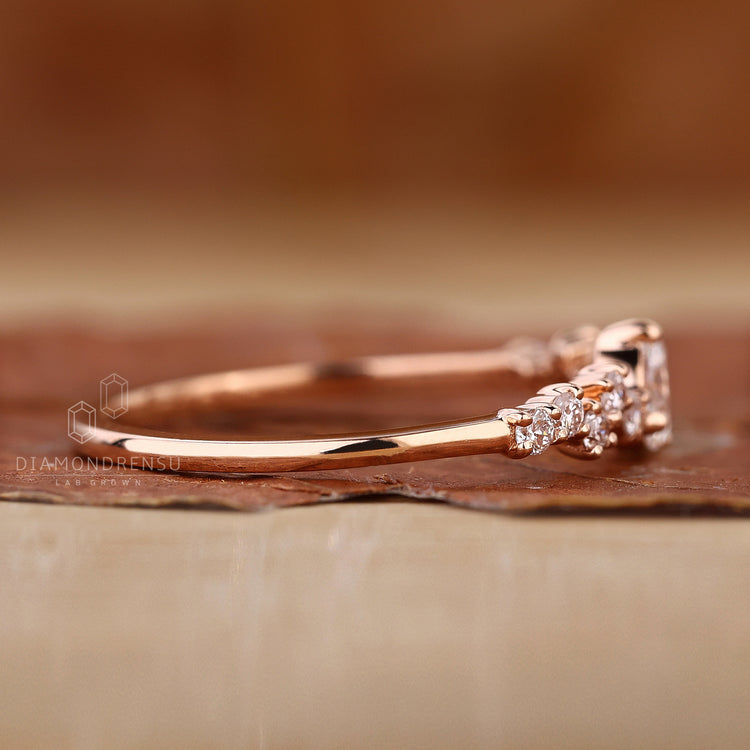 Round side stones add detail to this elegant rose gold ring.
