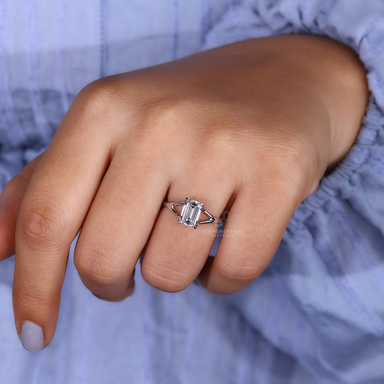 Model elegantly wearing a lab grown emerald cut diamond ring.
