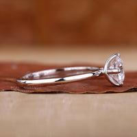 White gold ring with a round centre diamond.

