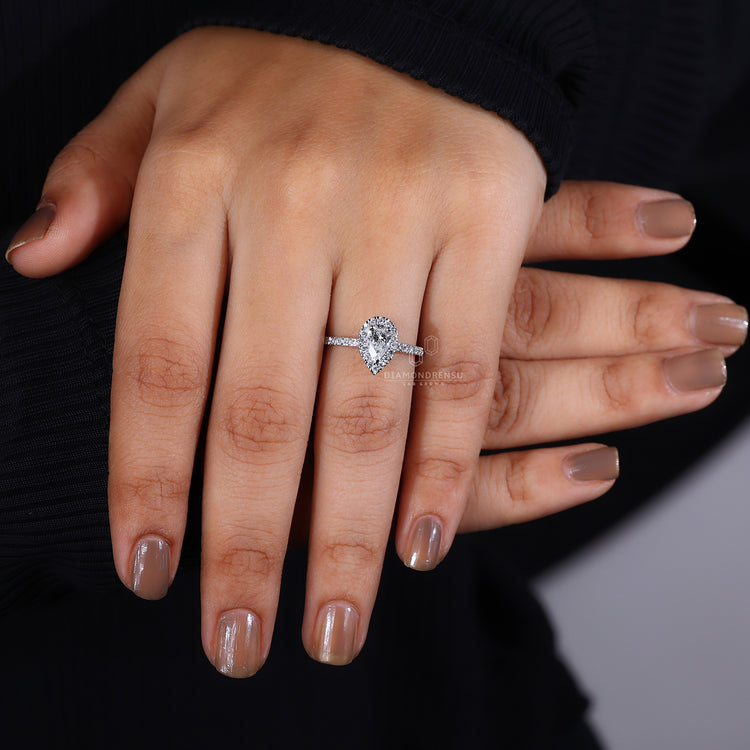 Buy pear halo engagement ring with pave band detail.
