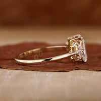 Yellow gold emerald cut ring with custom design.
