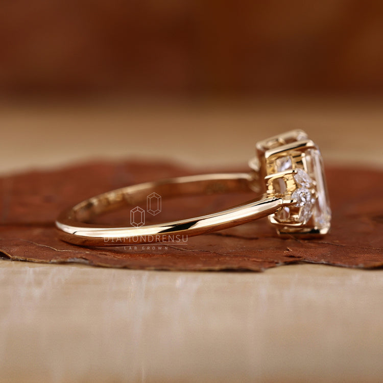 Yellow gold emerald cut ring with custom design.
