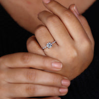 Shared prong engagement ring with a balanced stone layout.
