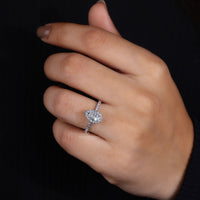 White gold pear halo engagement ring with custom design.
