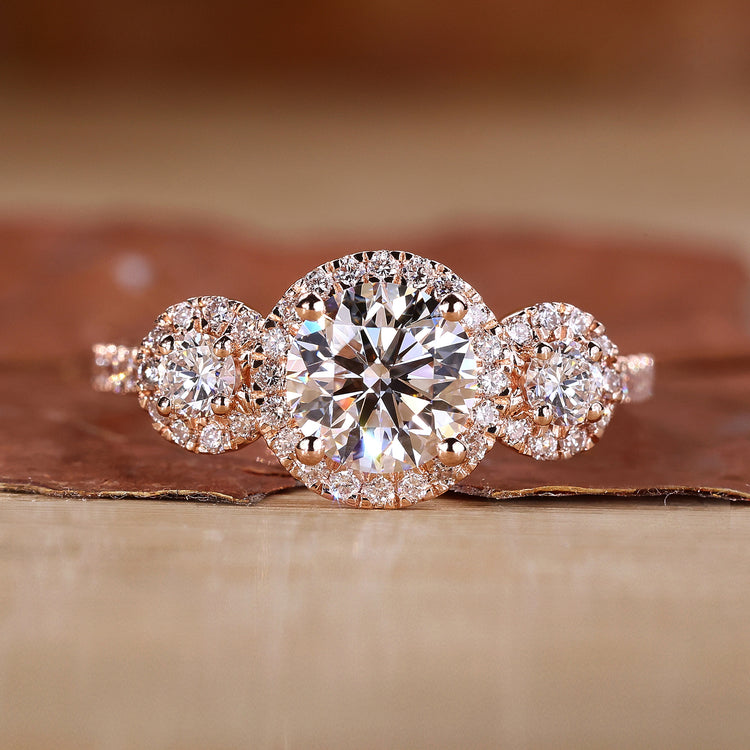 3 stone engagement ring with round cut diamonds in rose gold.
