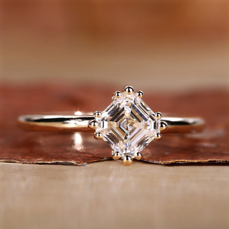 Asscher cut diamond solitaire ring in yellow gold.
