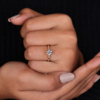 tab prongs holding round cut stones securely.
