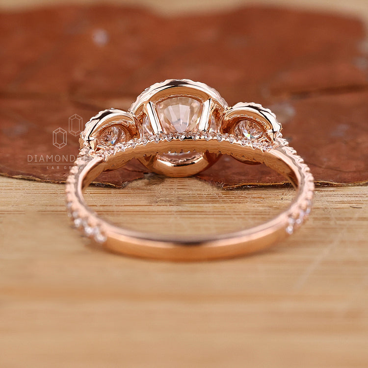 Rose gold engagement ring featuring a 3 stone layout.
