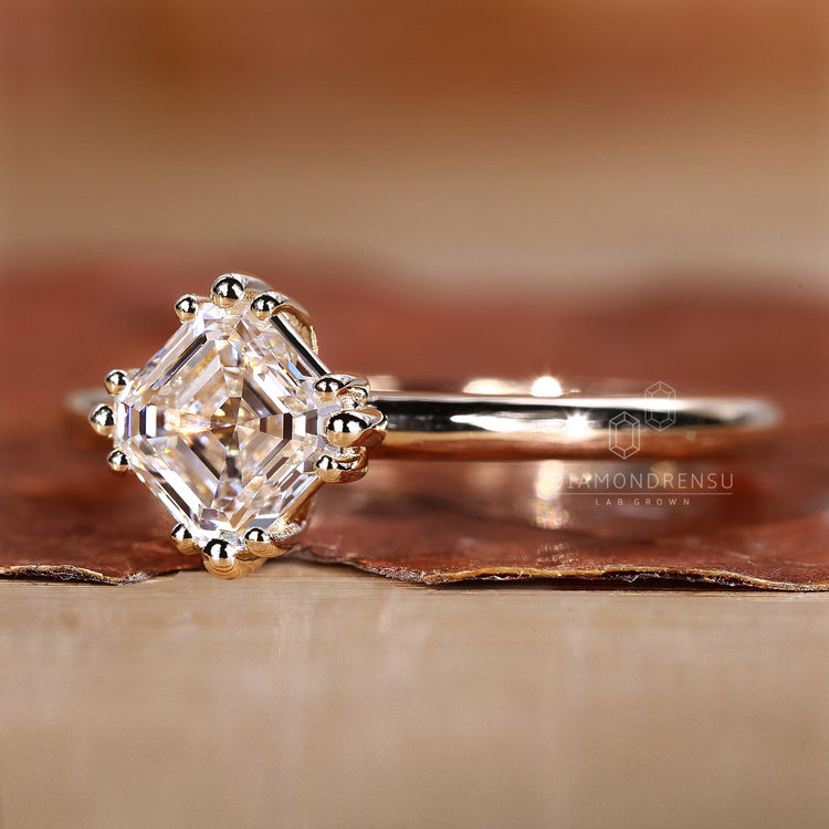 Simple diamond engagement ring with triple prong.

