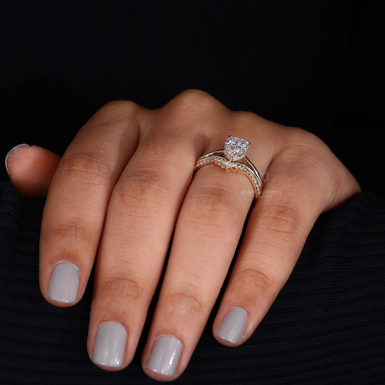 Pear and round diamond wedding band with IGI certified center stone.
