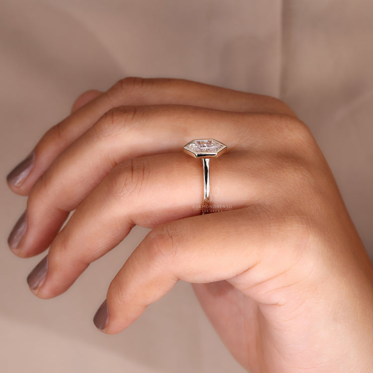 Simple engagement ring with bezel set diamond ring.
