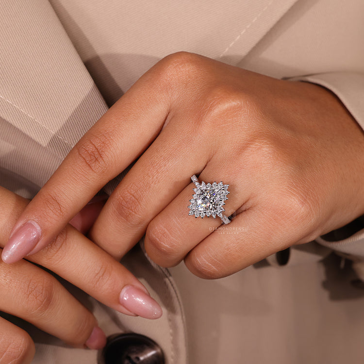 Custom diamond ring with marquise and round diamonds in halo style.

