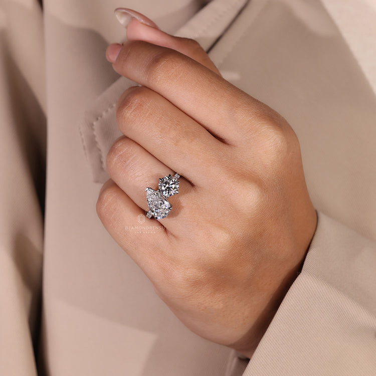 Pavé diamond ring with pear and round stones in custom design.
