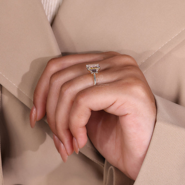 Emerald diamond ring with 3 stone engagement ring.
