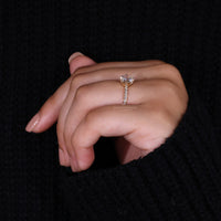 Round cut pave setting in yellow gold diamond ring.
