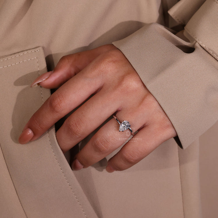 IGI certified pear cut diamond solitaire ring with claw prongs in a twisted band.
