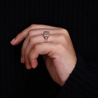 round diamond side stone in vintage engagement ring.
