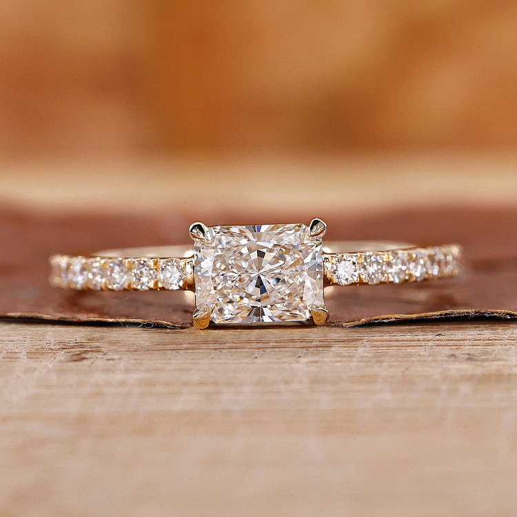 Radiant cut engagement ring in east to west setting.
