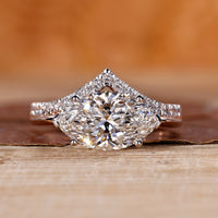 Two tone engagement ring with east west marquise diamond setting.
