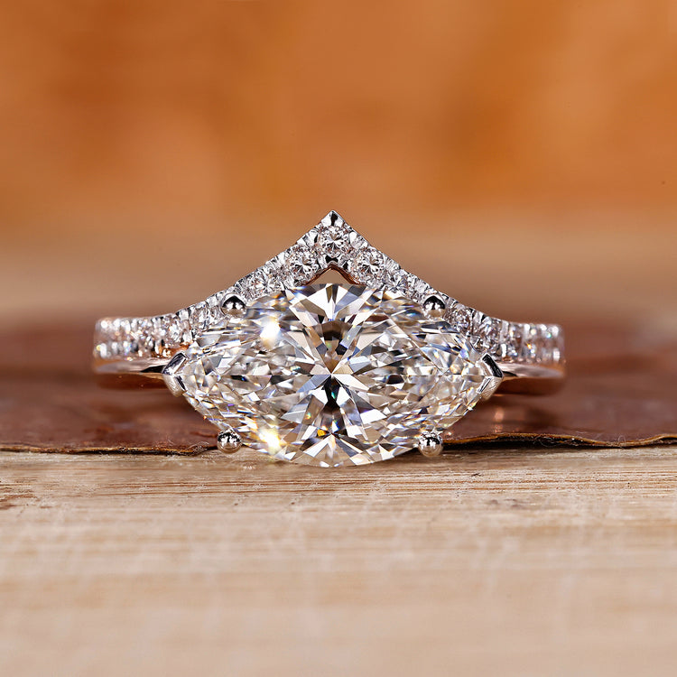 Two tone engagement ring with east west marquise diamond setting.
