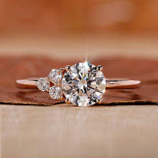 asymmetrical engagement ring with round cut side stone.
