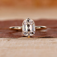 Old mine cushion cut diamond ring with hidden halo detail.
