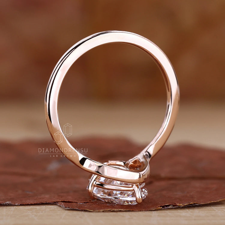 Diamondrensu AU compass prong ring with a marquise diamond in rose gold.