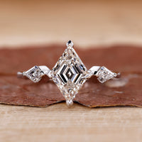 3 stone diamond engagement ring with kite side stones.
