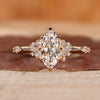 Marquise engagement ring with round side diamond.
