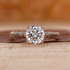 Knife edge ring with round cut diamond and pavé setting in rose gold.
